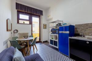 a kitchen with a blue refrigerator and a table at Toledo Apartment until 7 people 2 bathrooms in Naples