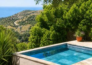 a swimming pool with a view of a mountain at Garden Residence Andros with Sea View & Pool in Gavrio +9 photos