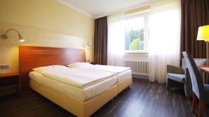 Postel nebo postele na pokoji v ubytování Garten-Hotel Ponick