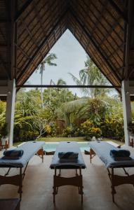 a room with two beds and a swimming pool at SEACLUB Siargao in General Luna