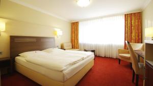 Postel nebo postele na pokoji v ubytování Garten-Hotel Ponick