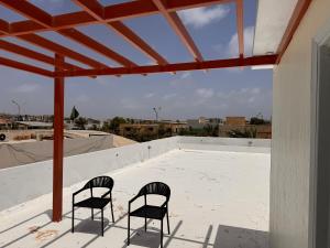 two chairs sitting on top of a roof at Sable d'Or Résidence by Star 'A' in Karachi