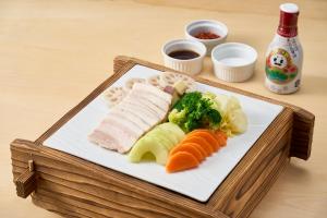 a plate of food with meat and vegetables on a table at APA Hotel Komatsu Grand in Komatsu