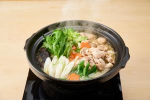 a pot of food on top of a stove at APA Hotel Komatsu Grand in Komatsu