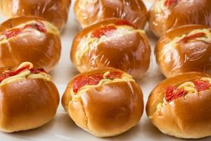 a bunch of hot dogs in buns on a tray at APA Hotel Komatsu Grand in Komatsu