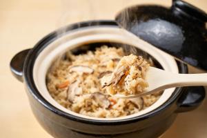 a wooden spoon holding a piece of food at APA Hotel Komatsu Grand in Komatsu