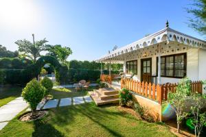 a small white house with a fence in the yard at Rawai Luxury Tents Pushkar in Pushkar