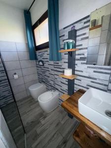 a bathroom with a sink and a toilet and a shower at Da Michele 2 in Costa Rei +24 photos