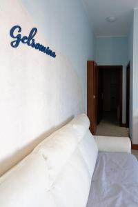 a room with a bed with a sign on the wall at Casa Gelsomina in Isola Bacucco