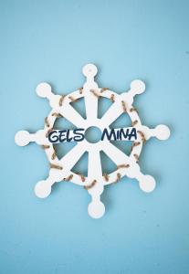 a wooden snowflake with a sign on a blue background at Casa Gelsomina in Isola Bacucco