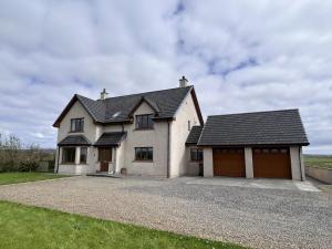 a large white house with a garage at Nistagar, Harray, Orkney - OR00604F in Harray