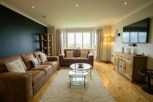 a living room with a couch and a table at Nistagar, Harray, Orkney - OR00604F in Harray