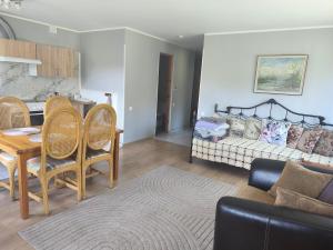 a living room with a couch and a table at Vormsi Ohvitseride maja korter nr 6 in Hullo