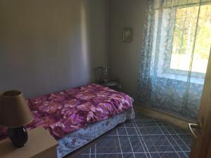 a small bedroom with a bed and a window at Vormsi Ohvitseride maja korter nr 6 in Hullo