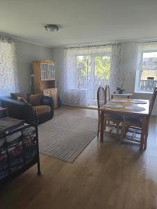 a living room with a table and a couch at Vormsi Ohvitseride maja korter nr 6 in Hullo