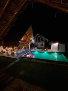 a view of a swimming pool at night at Boana hotel in Palomino