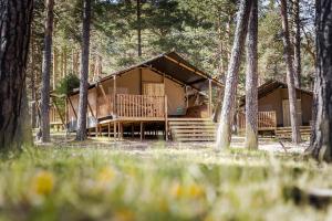 a cabin in the woods with trees at Camping Urbion in Abejar