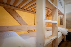 two bunk beds in a room with yellow walls at Camping Urbion in Abejar +107 photos