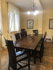 a dining room with a wooden table and chairs at Altstadtmeise Elegance in Meisenheim +22 photos