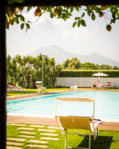 a chair sitting next to a swimming pool at Resort & Winery Bosco De Medici in Pompei
