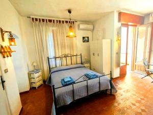 a bedroom with a bed and a refrigerator at Sunrise Stagnone - Relax Sea Rooms in Marsala