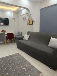 a bedroom with a bed and a couch and a table at BlueRoyal Home Sultanahmet in Istanbul