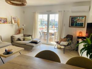 a living room with a couch and a table at Marina with pool in Aigues-Mortes