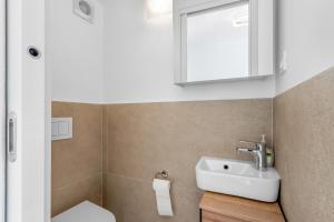 a bathroom with a white sink and a mirror at Charming Casa Piccola in Draga Bašćanska +7 photos