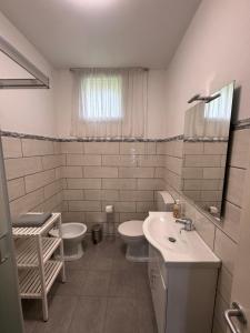 a bathroom with two toilets and a sink at Hi Malpensa - Apartment in Case Nuove +7 photos