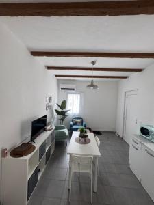 a living room with a table and a tv at Hi Malpensa - Apartment in Case Nuove