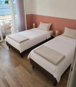 two beds sitting next to each other in a room at JenAlya in Vallauris