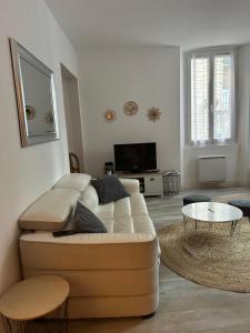 a living room with a couch and a table at fontaine in Aups