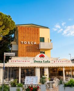 a building with a sign that reads tosca restaurant at Hotel Garni Tosca in Lido di Jesolo
