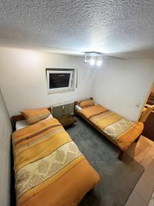 a room with three beds and a tv in it at Nice Apartment in Mörfelden in Mörfelden-Walldorf