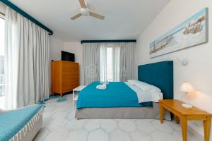 a bedroom with a blue bed and a table at B&B Casa di Emma in Porto Cesareo