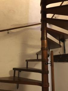 a wooden spiral staircase next to a wall at Altstadtmeise Rustika in Meisenheim +23 photos