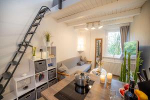 a kitchen with a table and a living room at Tiny Loft Harz in Sankt Andreasberg
