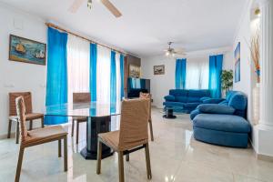 a living room with a glass table and chairs at Hauzify I Casa Peralta in Les tres Cales