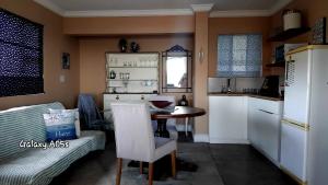 a kitchen with a table and a small kitchen with a counter at Seas the Breeze in Boknes +33 photos