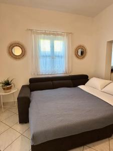 a bedroom with a bed and a window at Casa d' Irene fully equipped House in Koufonisia