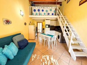 a living room with a green couch and a staircase at Ostrica in Lumio +8 photos