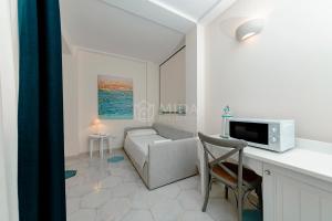 a living room with a couch and a table at B&B Casa di Emma in Porto Cesareo