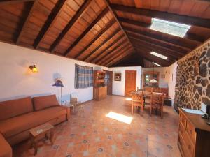 a living room with a couch and a table at Casa Glorieta in Los Llanos de Aridane +7 photos