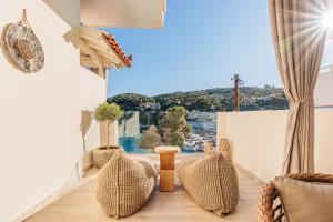 a room with chairs and a large window at Casa Nina in Patitiri