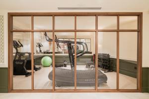 a room with a gym with a treadmill at Hôtel Lepoussin in Cannes
