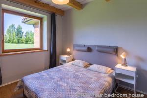 a bedroom with a bed and a large window at Prie Trakų in Petkėniškės +54 photos