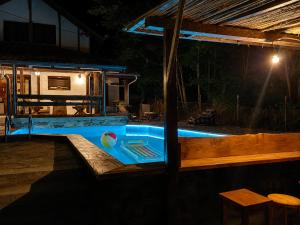 a swimming pool in a house at night at villa vidalis in Veliko Golovode +6 photos