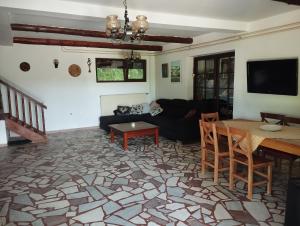 a living room with a couch and a table at villa vidalis in Veliko Golovode
