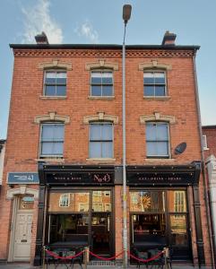 a brick building with windows on a street at One bedroom loft apartment central Worcester in Henwick