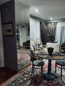 a living room with a table and chairs at La Grace Guestrooms in Kroonstad